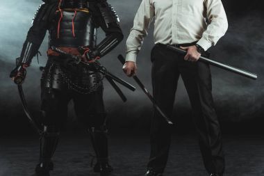 cropped shot of modern man and samurai with katana swords on black clipart