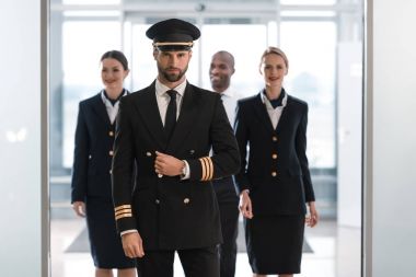 Pilot with stewardesses clipart