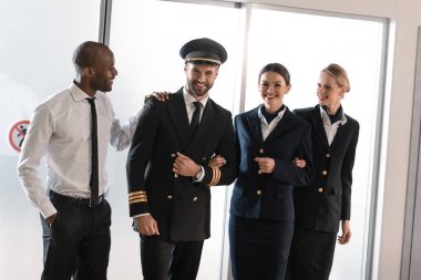 happy aviation personnel team in professional uniform clipart
