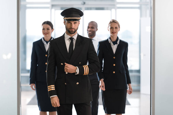 Pilot with stewardesses
