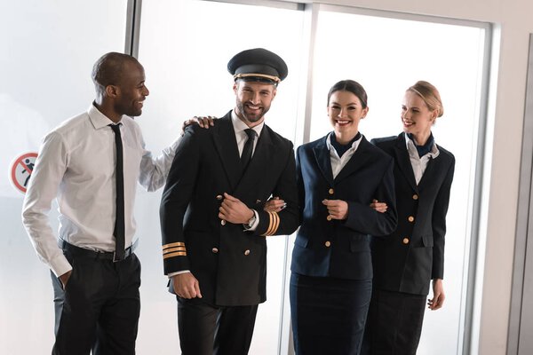 happy aviation personnel team in professional uniform