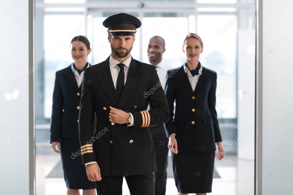 Pilot with stewardesses