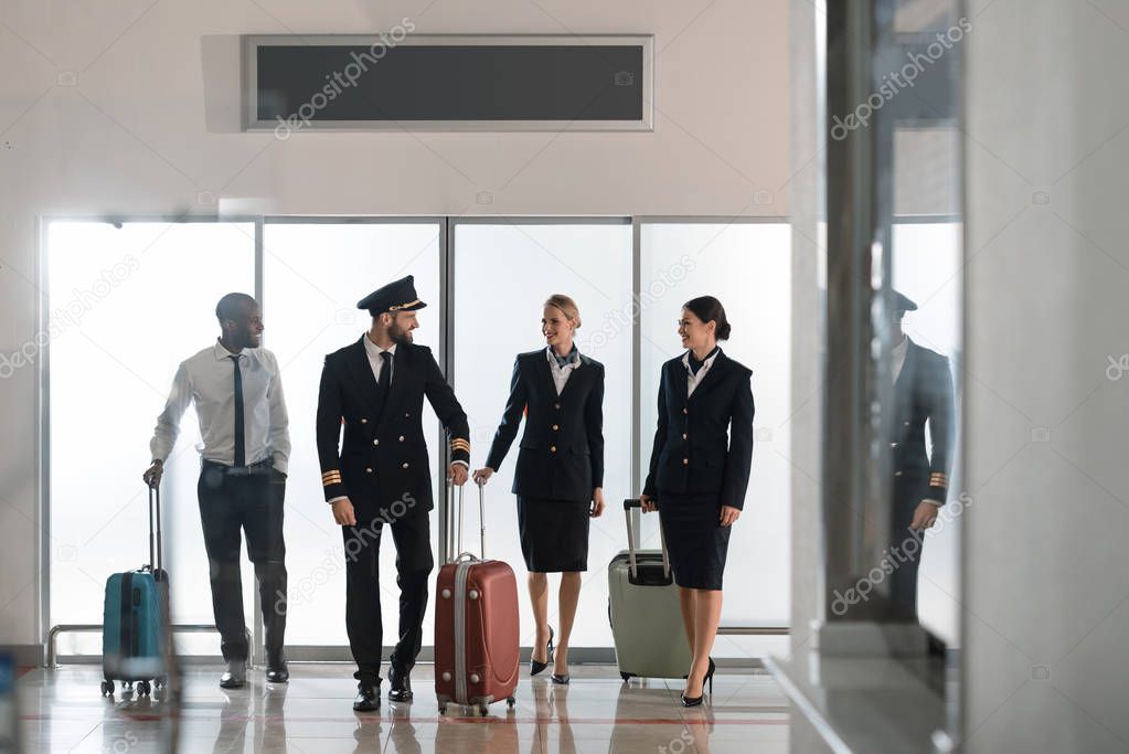 aviation personnel team walking by airport loggy