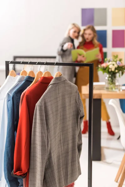 Stylish Dressmakers Working Modern Office Clothes Foreground — Free Stock Photo