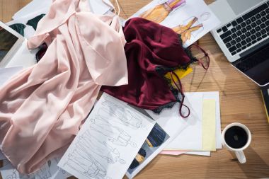 top view of messy fashion designer workplace clipart
