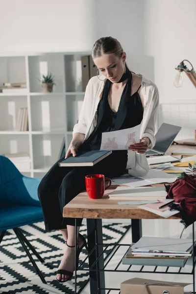 Young Fashion Designer Sitting Work Desk Looking Sketches — Free Stock Photo