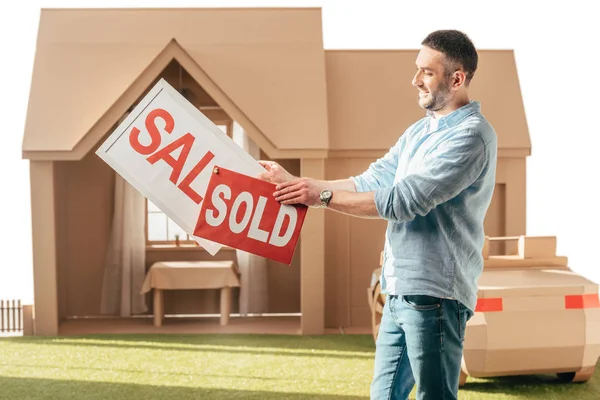 Man Holding Sale Sold Signboards Front Cardboard House Isolated White — Stock Photo, Image
