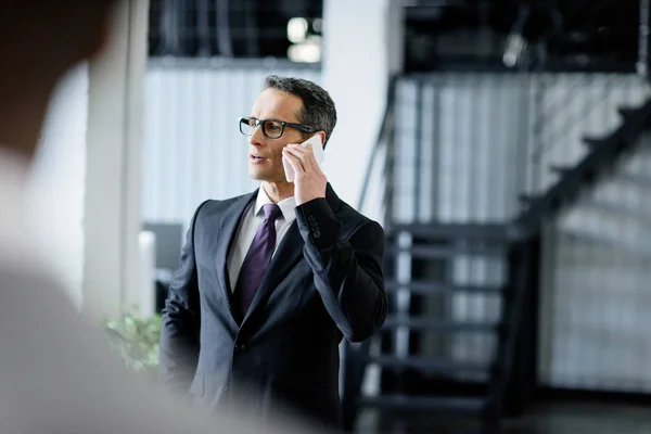 Businessman Eyeglasses Talking Smartphone Office — Stock Photo, Image