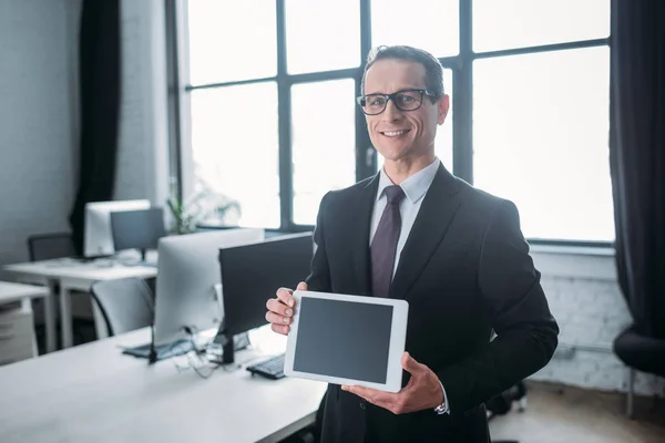 Portrait Smiling Businessman Showing Tablet Blank Screen Hands Office — Stock Photo, Image