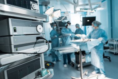 four surgeons preparing in operating room clipart