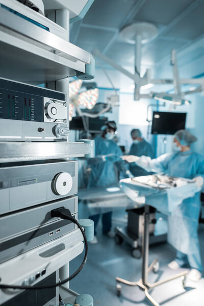 four surgeons in operating room in hospital