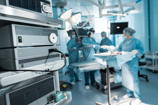 four surgeons preparing in operating room