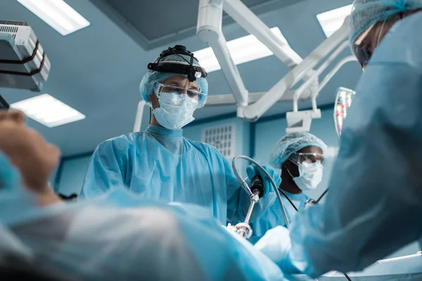 Multiethnic Surgeons Operating Female Patient — Stock Photo, Image