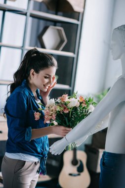young woman pretending to receive flowers from layman doll, perfect relationship dream concept clipart