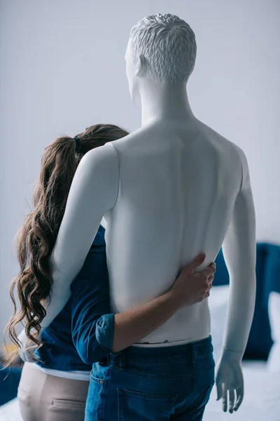back view of woman hugging layman doll, perfect relationship dream concept
