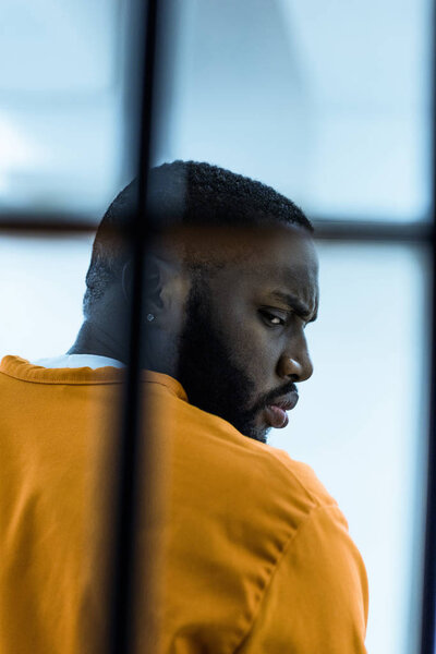 african american prisoner in prison cell
