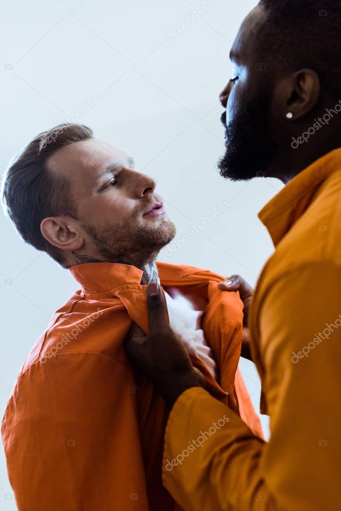 african american prisoner threatening cellmate isolated on white