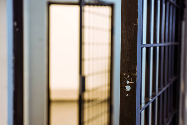 prison bars and empty prison cell