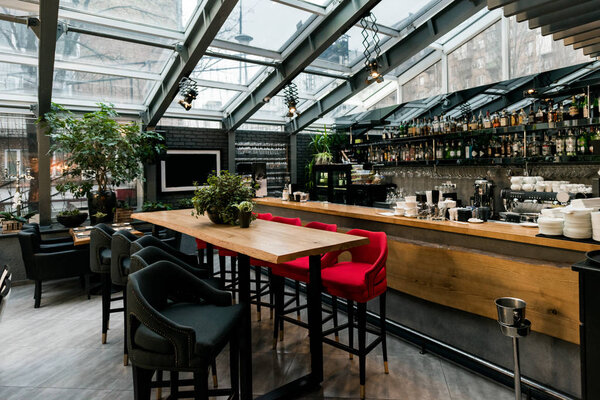 view of stylish empty cafe with arranged tables and chairs for visitors