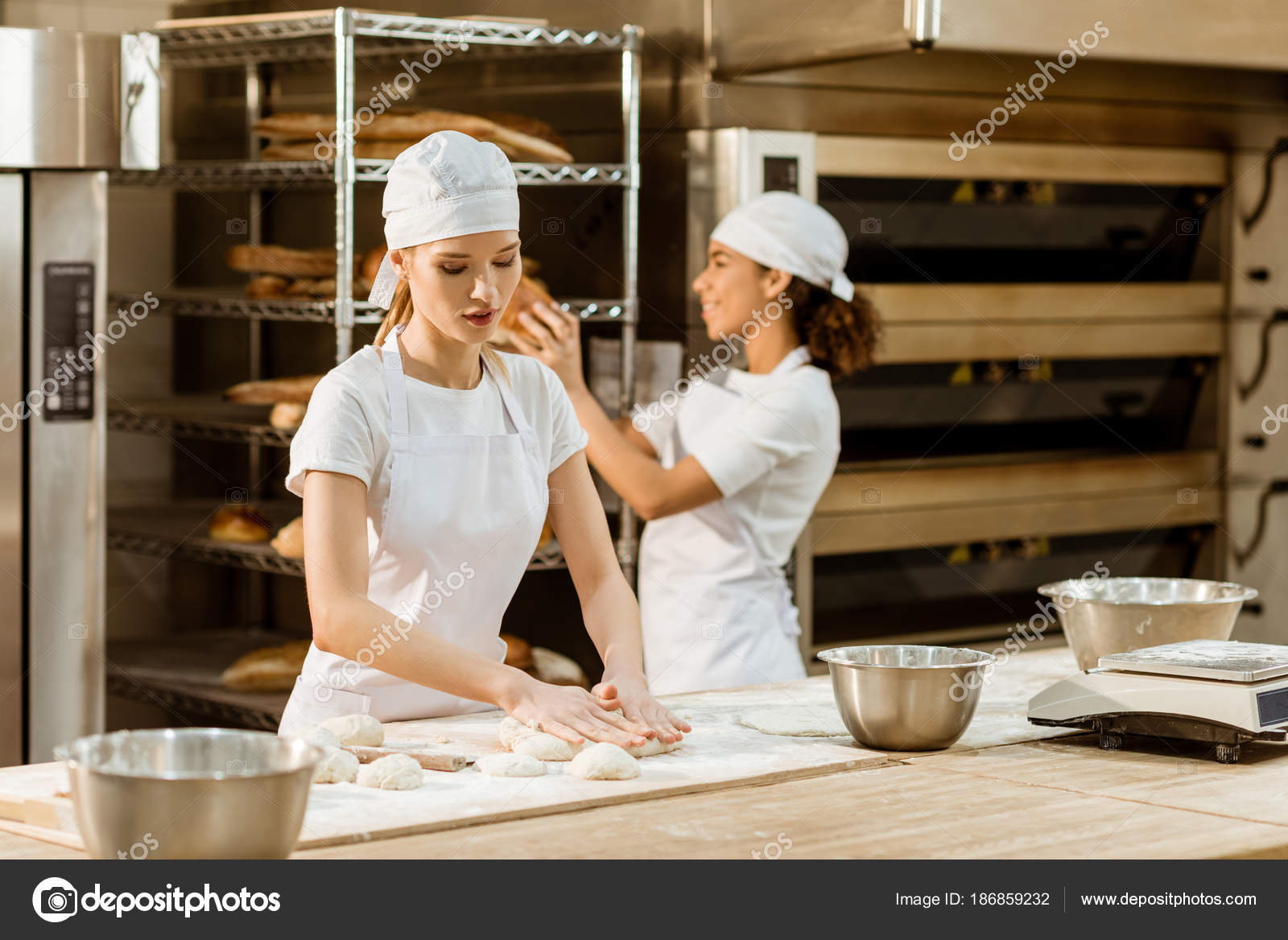Young Attractive Female Bakers Working Together Baking Manufacture