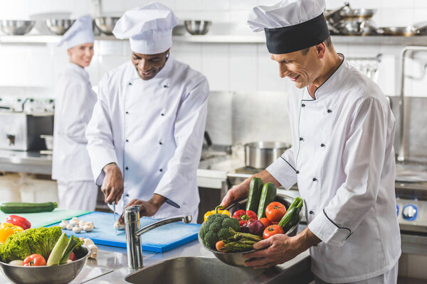 multicultural chefs preparing at restaurant kitchen