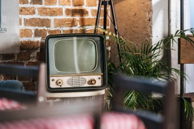 vintage tv with blank screen in 50s style interior clipart