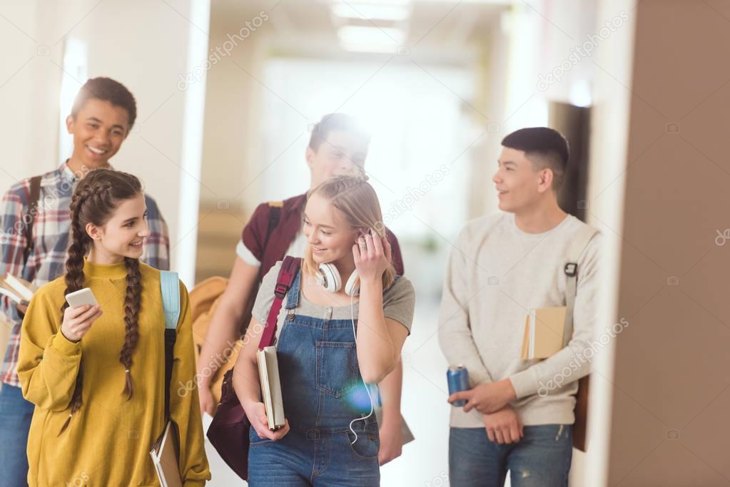 group of high school classmates spending time at school corridor together