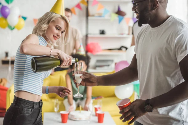Young Woman Pouring Champagne Glass African American Man Hands — Free Stock Photo