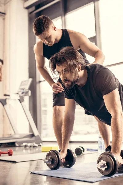 Handsome Sportsman Doing Push Ups Dumbbells Gym — Free Stock Photo