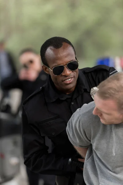 African American Policeman Sunglasses Arresting Young Man — Stock Photo, Image