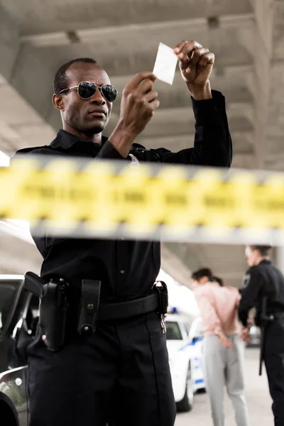 Policeman Sunglasses Holding Plastic Zipper Drugs While His Partner Arresting — Stock Photo, Image