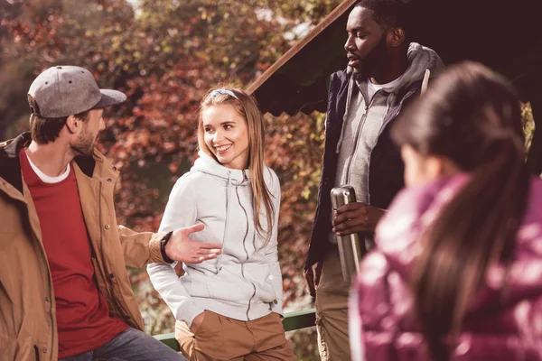 Young travelers resting near river — Stock Photo