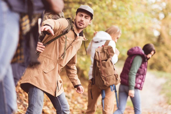 Friends backpackers in autumn forest — Stock Photo