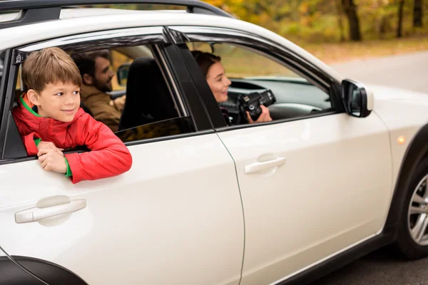 Smiling boy looking through car window — Stock Photo