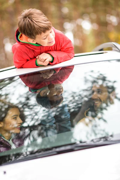 Adorable boy standing in car sunroof — Stock Photo