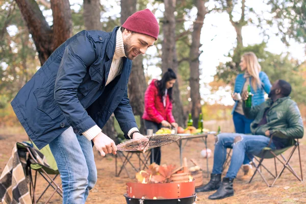 Man kindling fire on grill — Stock Photo