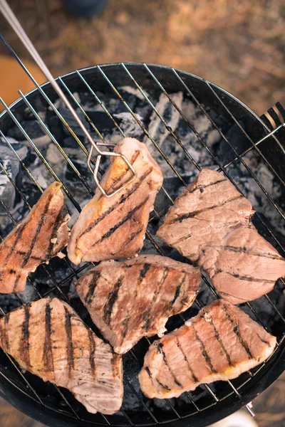 Grilling meat on charcoal grill — Stock Photo