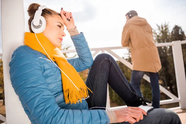 Hermosa mujer en auriculares escuchando música - foto de stock