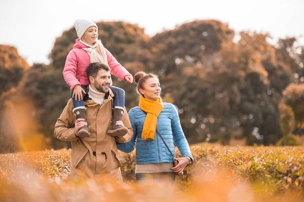 Happy family walking in park — Stock Photo