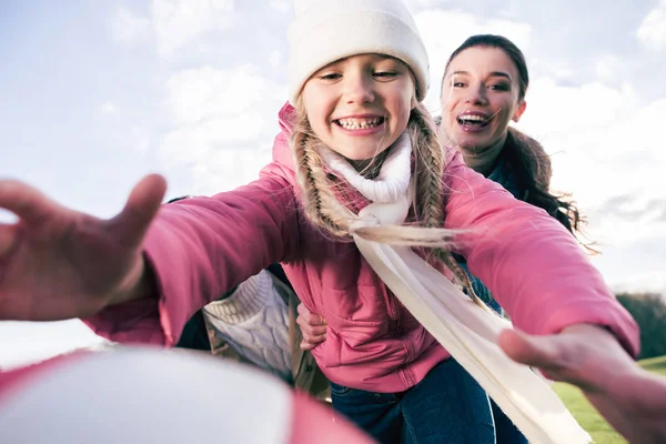 Smiling mother holding happy daughter — Stock Photo