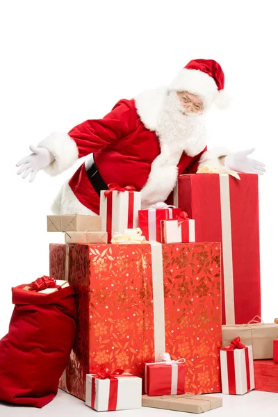 Santa Claus with pile of Christmas gifts — Stock Photo