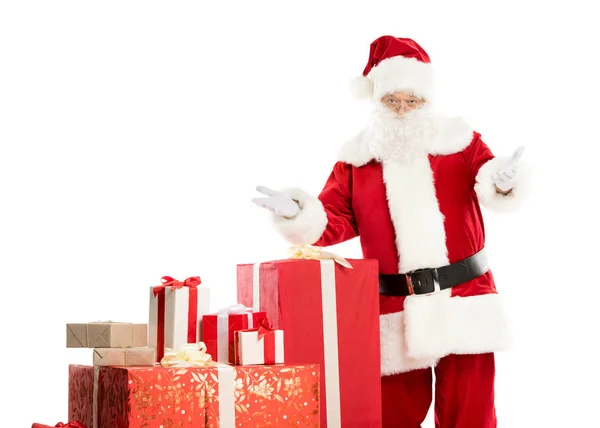 Santa Claus with pile of Christmas gifts — Stock Photo