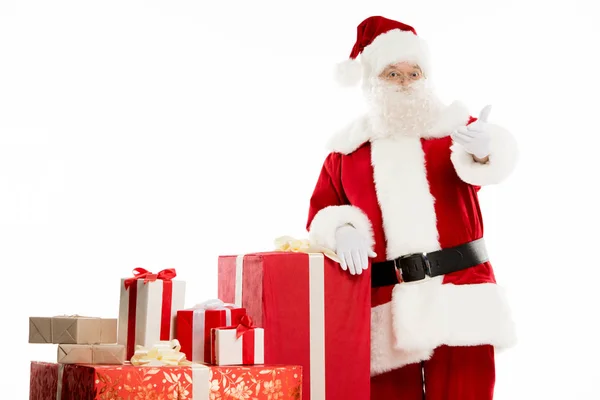 Santa Claus with pile of Christmas gifts — Stock Photo