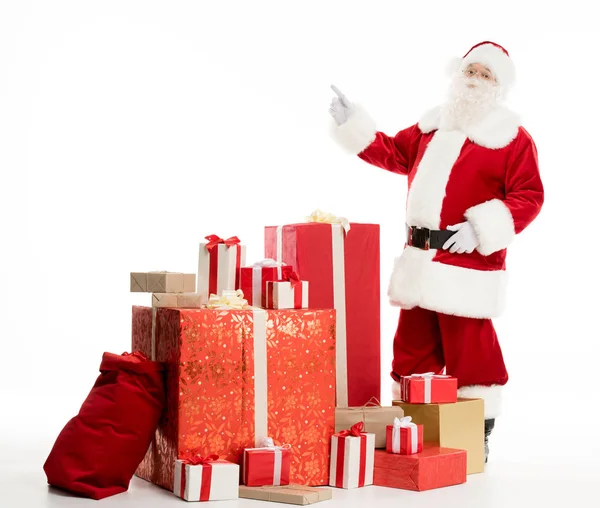 Santa Claus with pile of Christmas gifts — Stock Photo