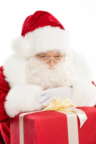 Santa Claus with pile of Christmas gifts — Stock Photo