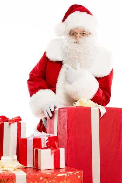 Santa Claus with pile of Christmas gifts — Stock Photo
