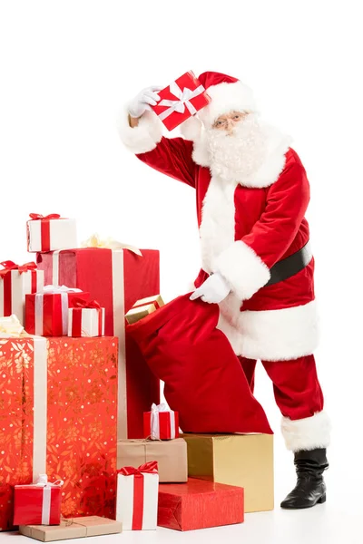 Santa Claus taking out Christmas gifts from sack — Stock Photo