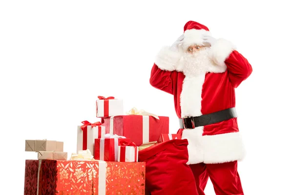 Santa Claus with pile of Christmas gifts — Stock Photo