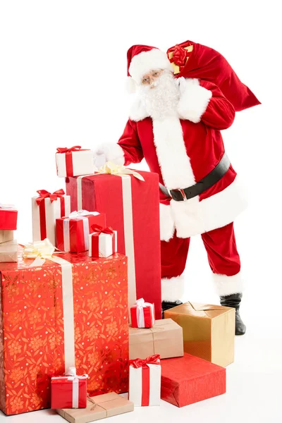 Santa Claus with pile of Christmas gifts — Stock Photo