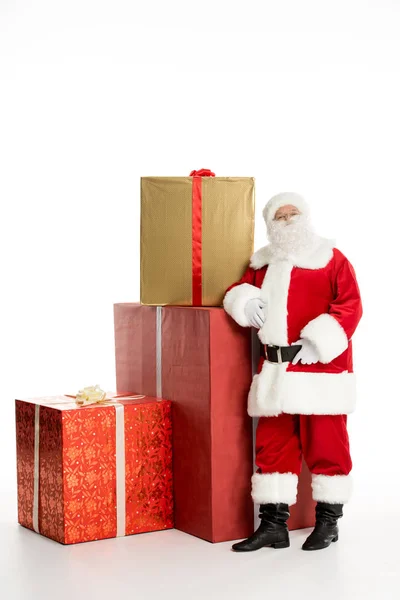 Santa Claus with pile of Christmas gifts — Stock Photo